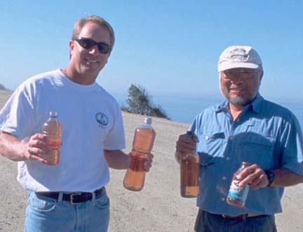 Photo of Pete Thomas and Gene Kira with gas bottles on Ensenada toll road.
